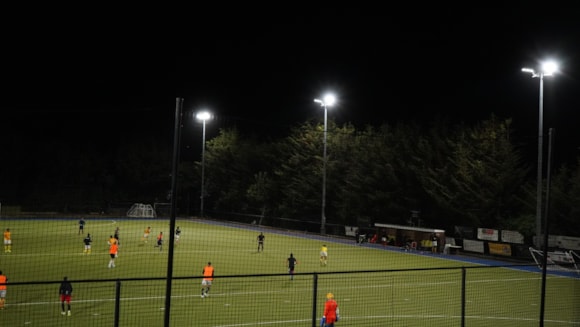 a gymkana hockey match under floodlights