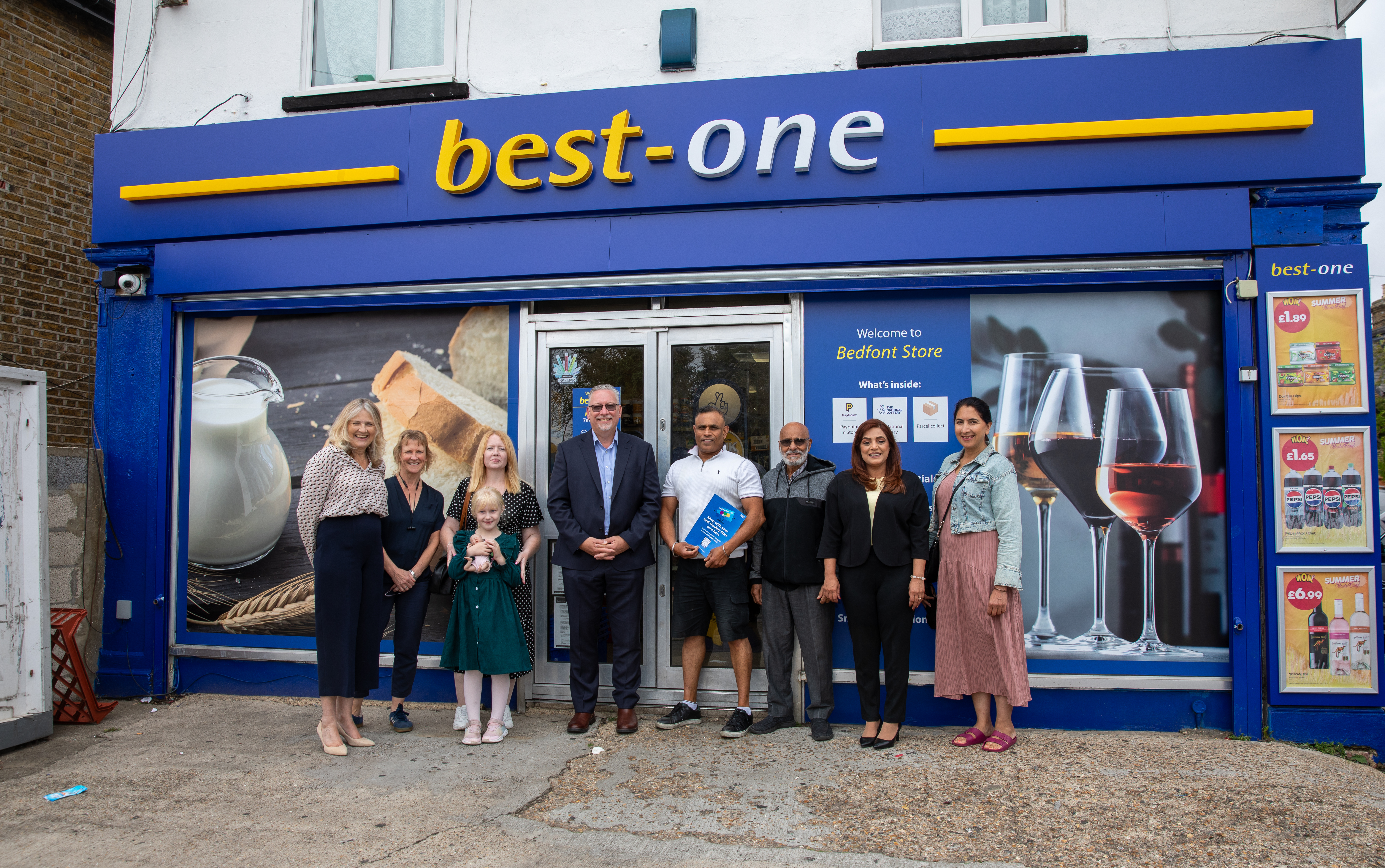 8 people standing outside the best one shop
