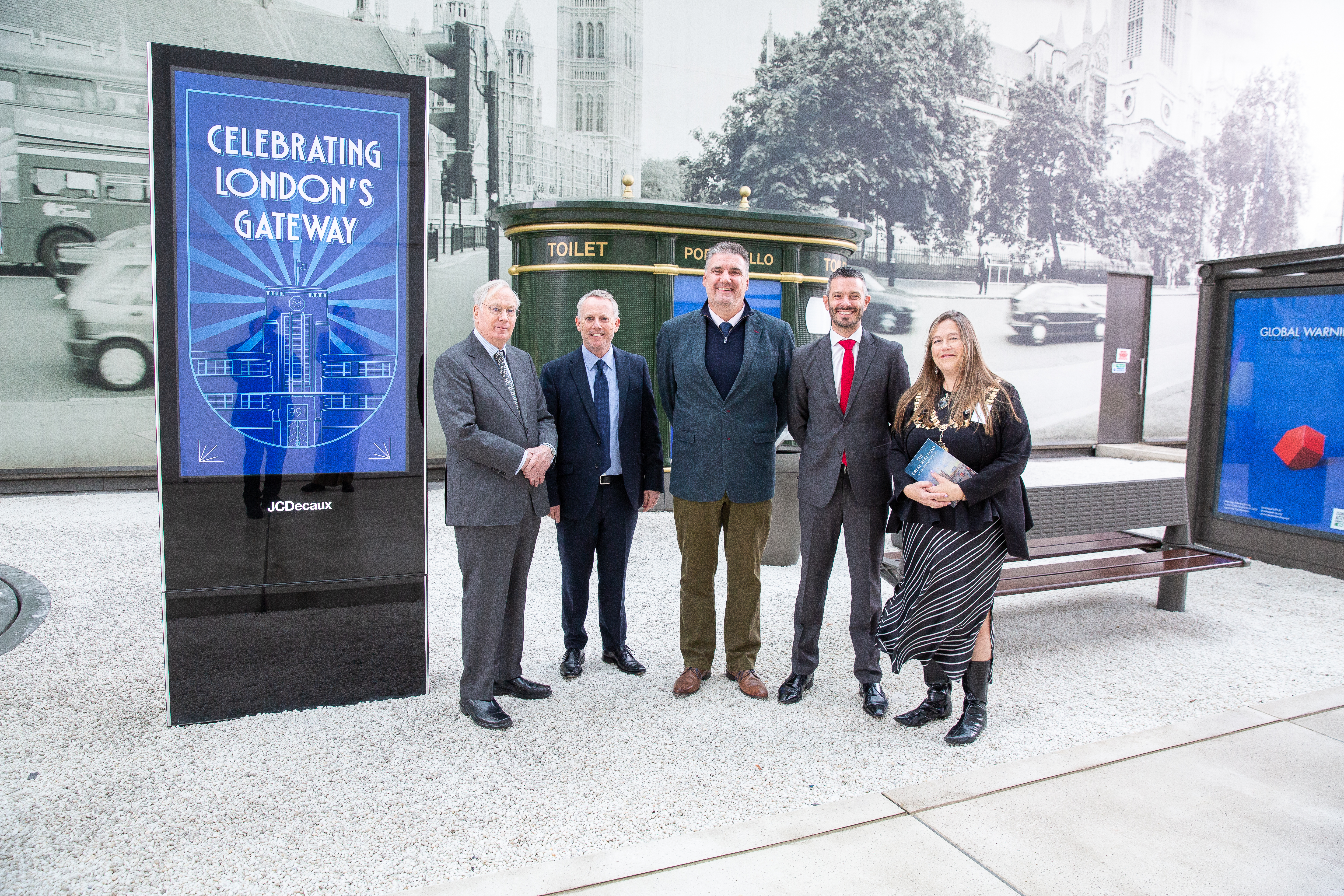 4 people stood next to a digital display board