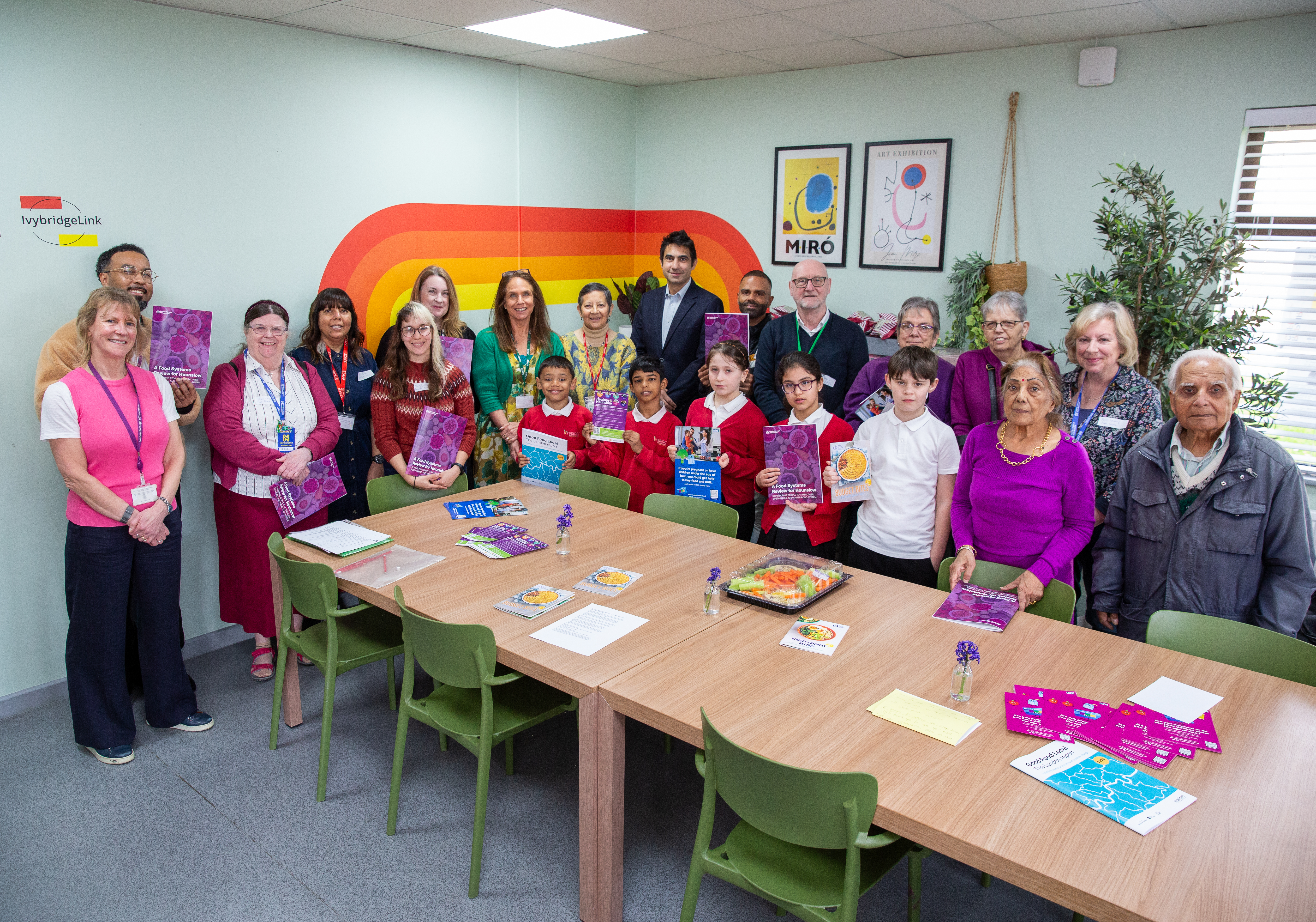 A group of people stood around a table