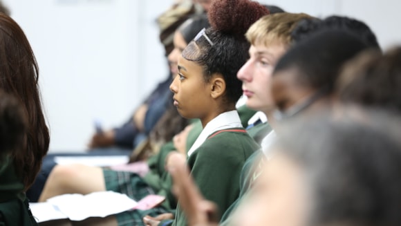 School children in uniform sitting in a row