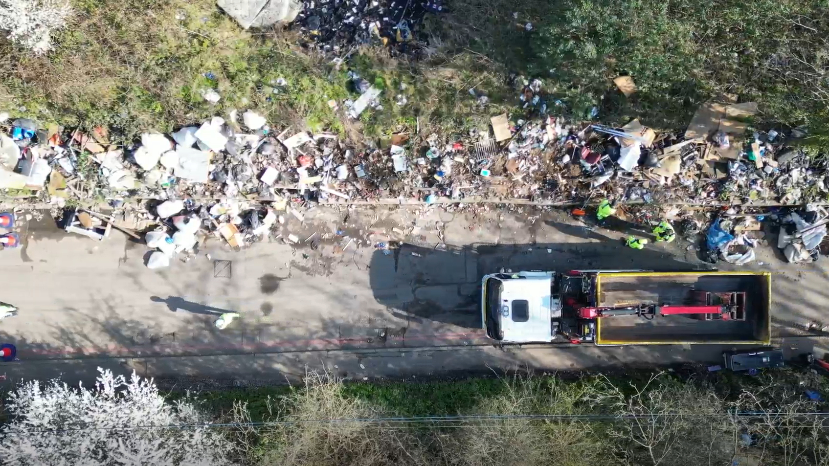 An aerial view of church road showing a truck surrounded by flytipped waste
