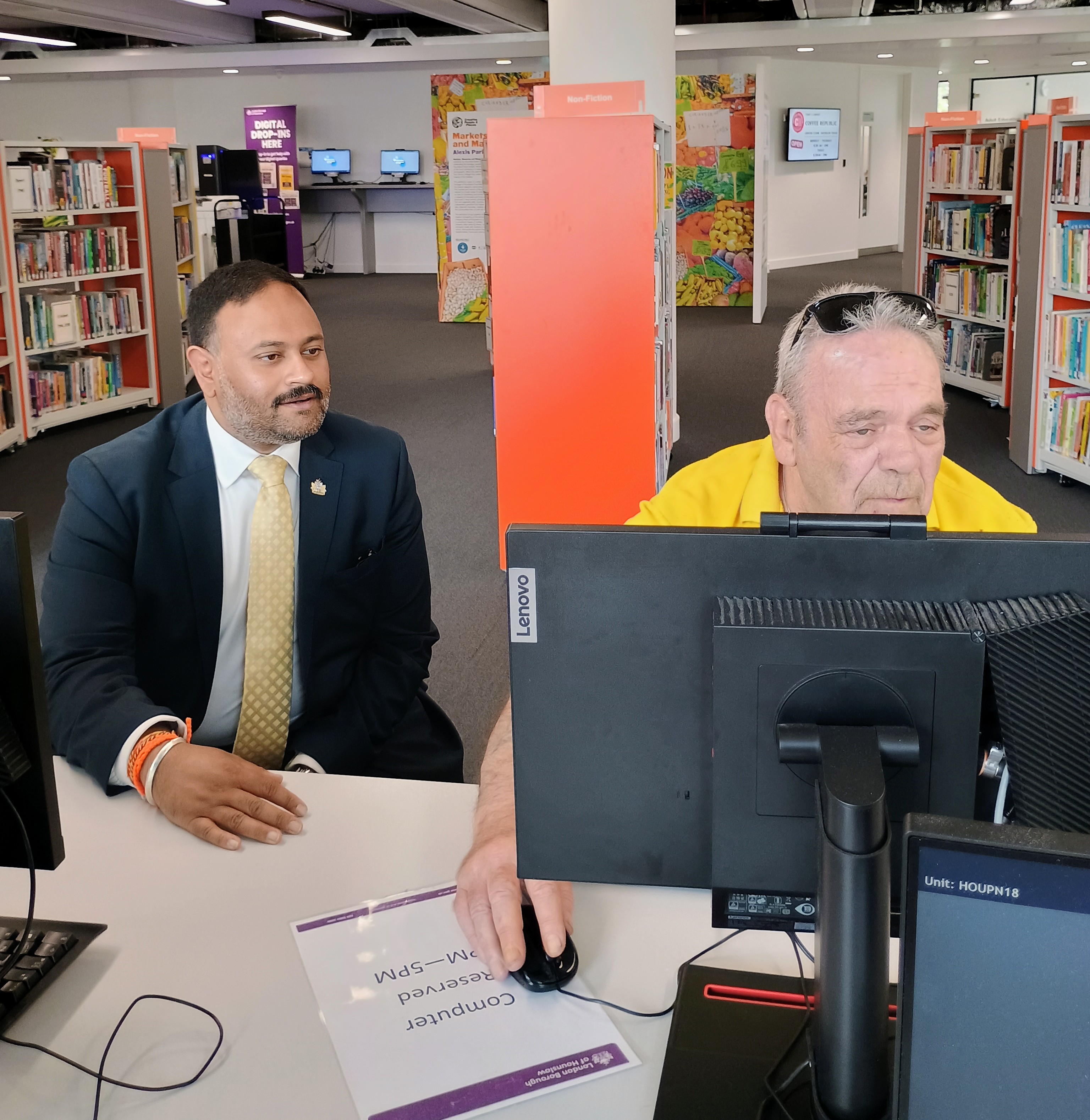 Cllr Rajawat with a resident learning digital skills at a drop-in event