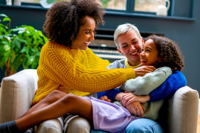 Couple with child hanging out happily at home.