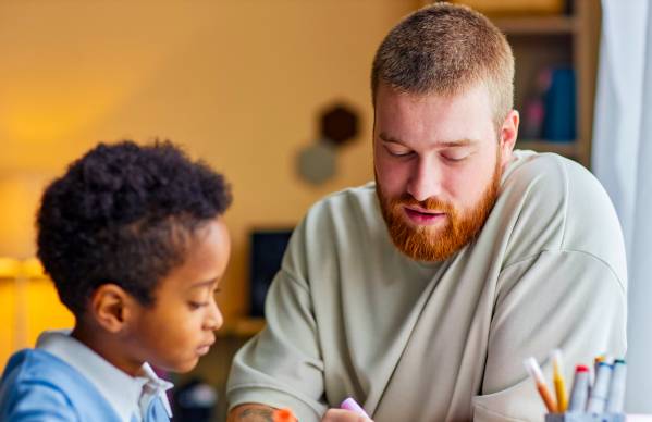 Adult and child at table doing art