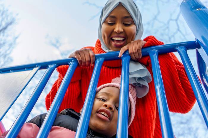 Woman and child playing in playground