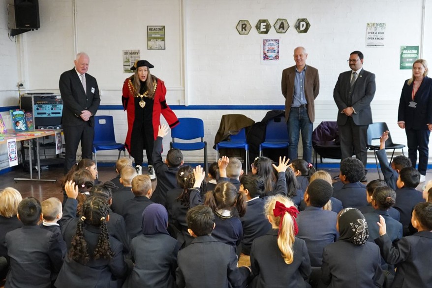 Children at Oriel Primary school collecting books from Business in the Community representatives