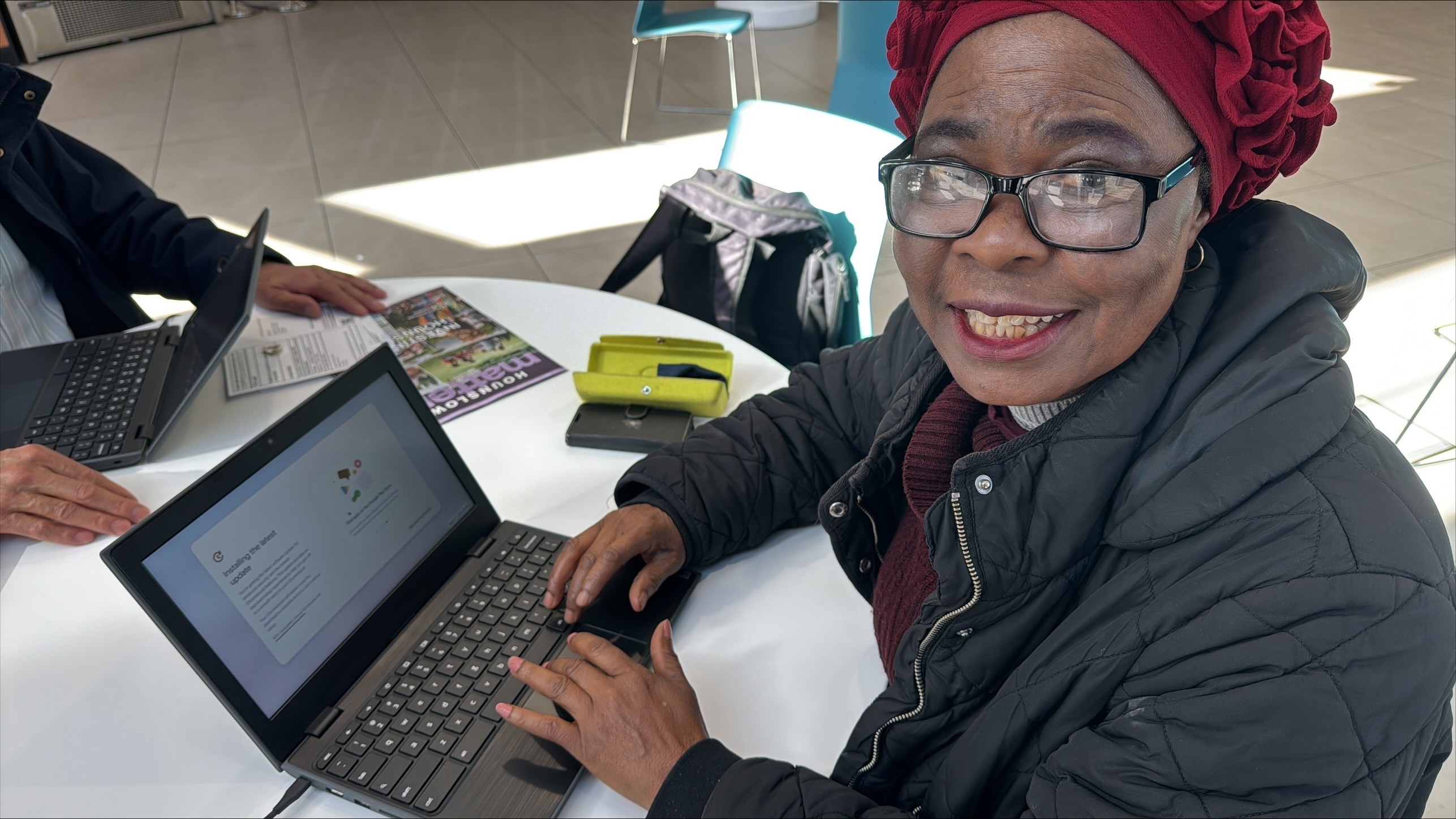 Resident receiving her free laptop to enable her to get online
