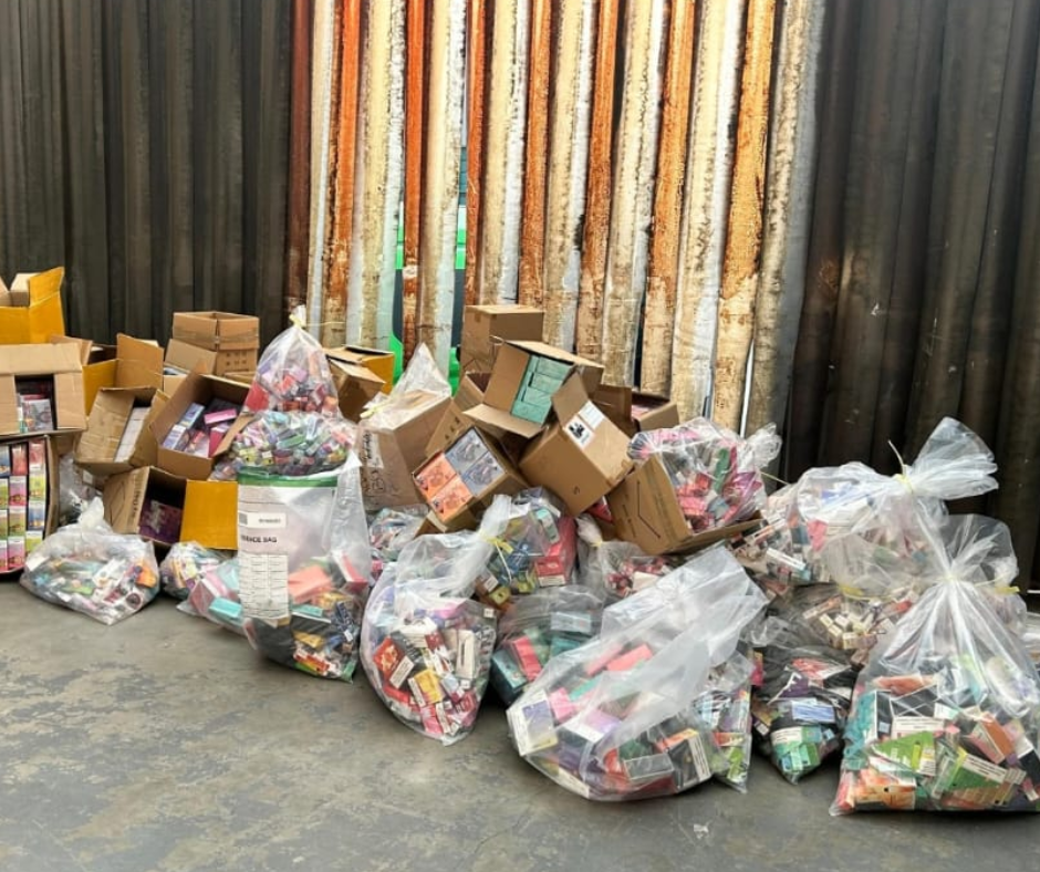 Seized tobacco and vape products on the floor in plastic see-through bags