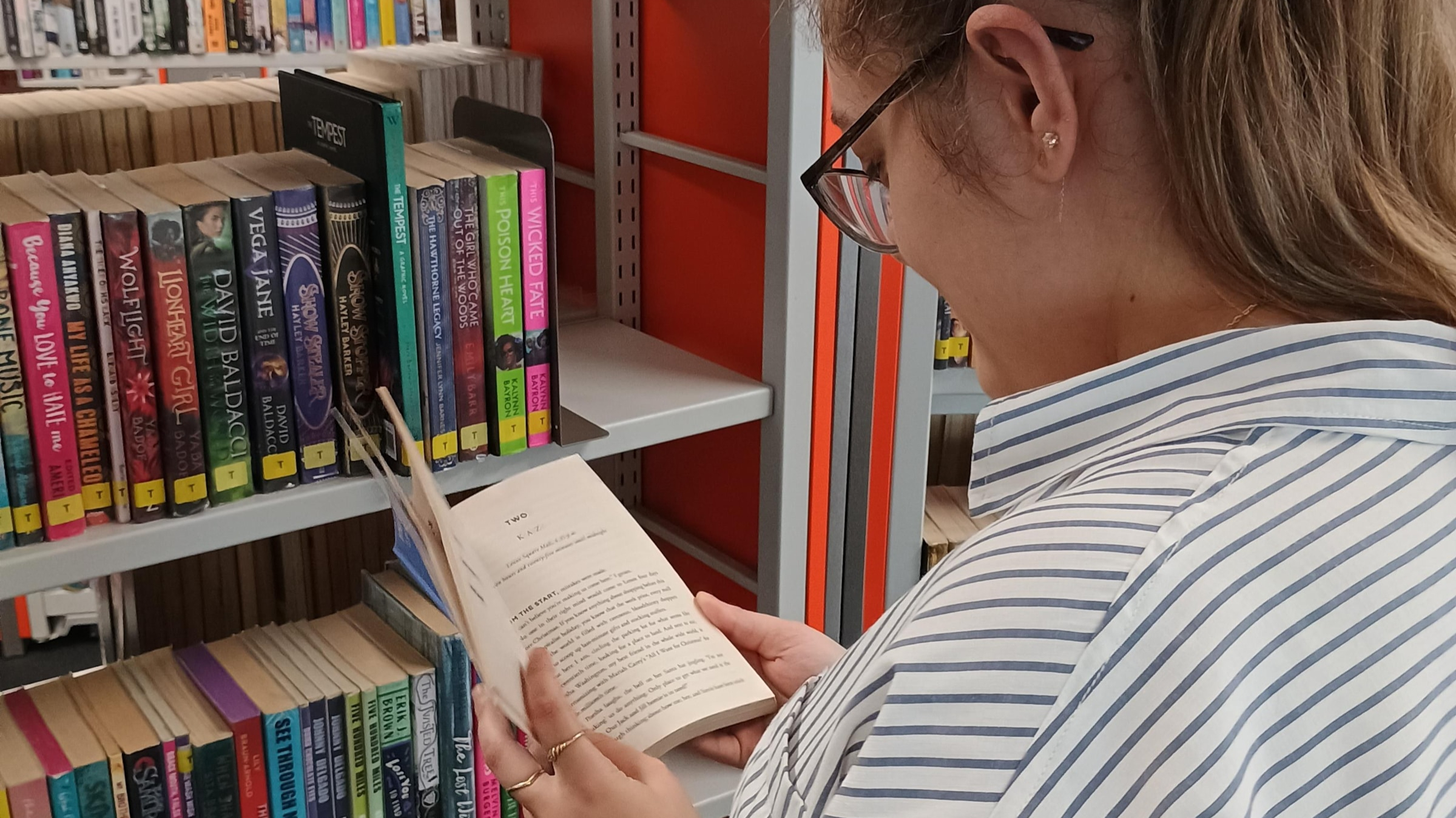 A student looking at a book in Hounslow Library