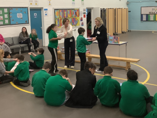 Children at Oriel Primary school collecting books from Business in the Community representatives