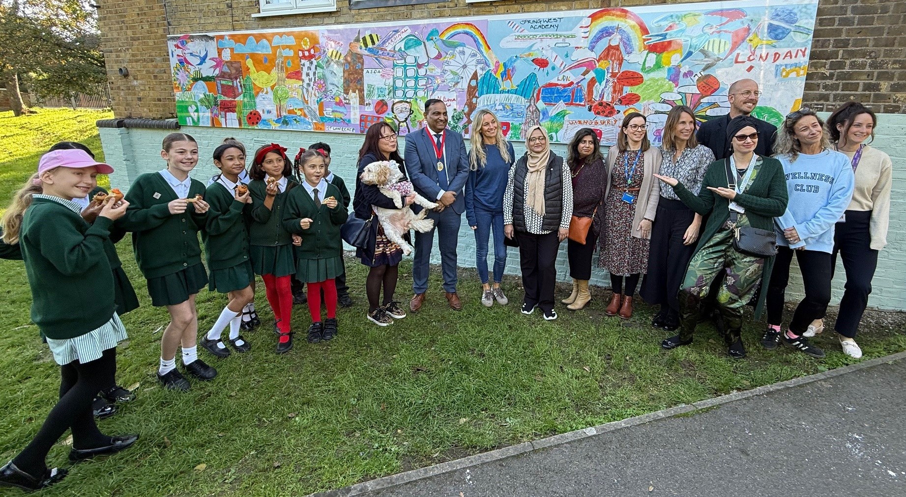 Deputy Mayor Councillor Junue Meah and Councillor Farah Kamran join artists, volunteers and school children at the mural unveiling