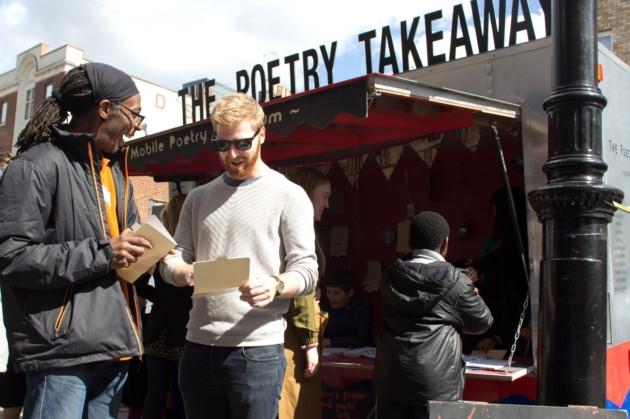 Image of two people interacting at the Poetry Takeaway pop-up