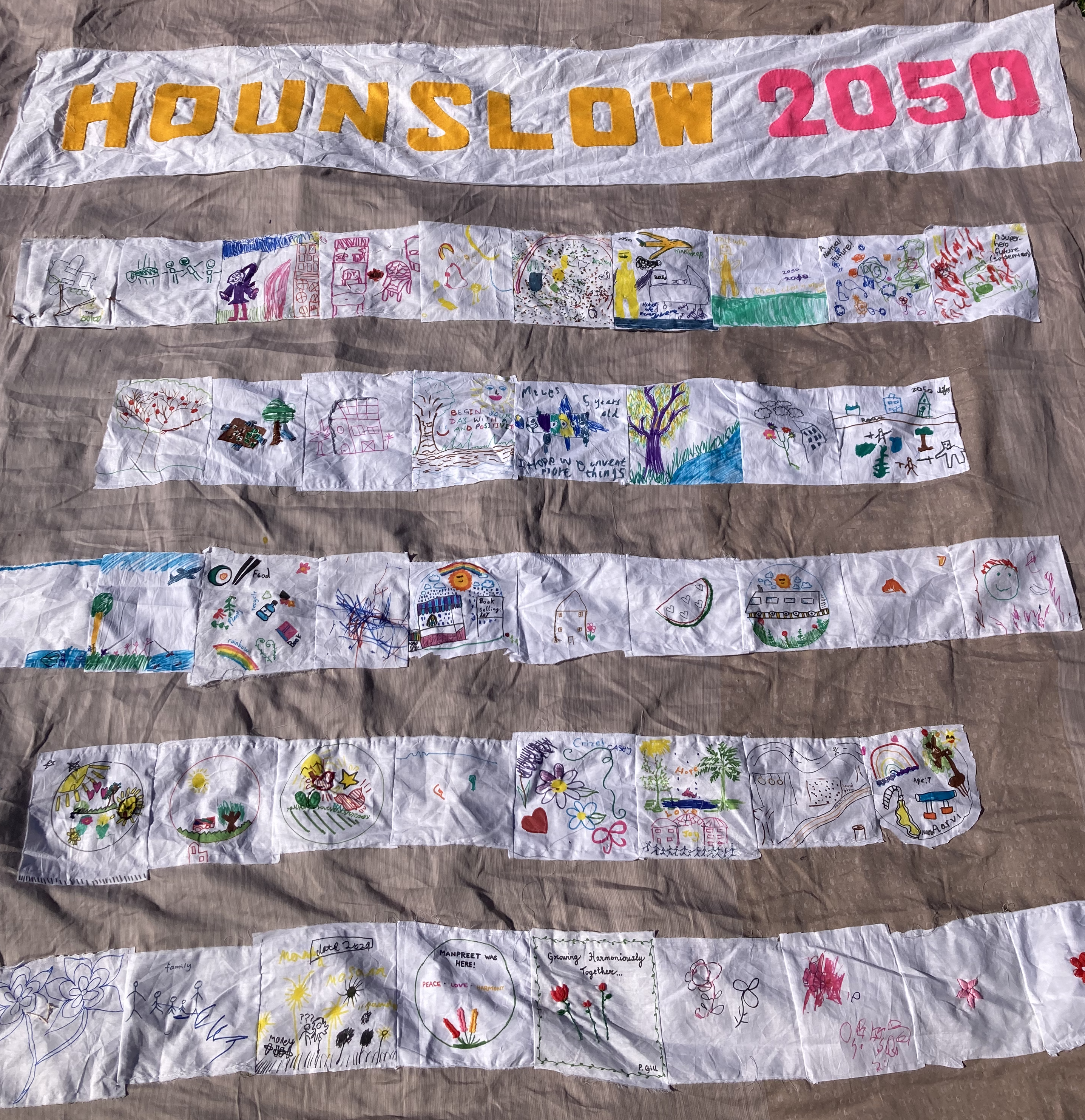 Various artworks sewn into a large piece of material