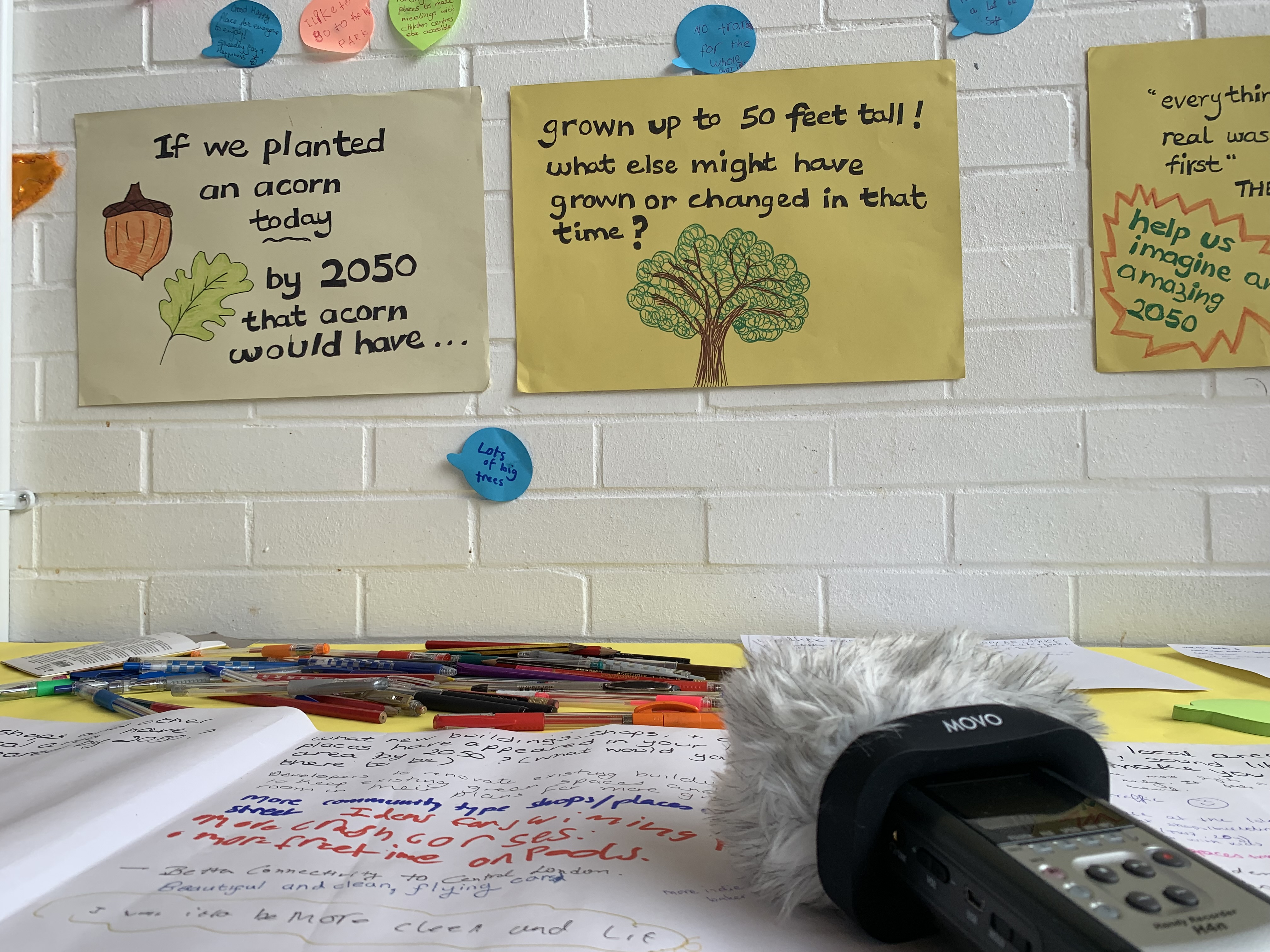 Image of storytelling workshop table and examples pinned to the wall